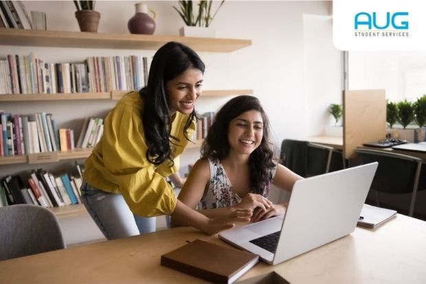 Student completing a UCAS application on a laptop with UK University brochures: UCAS application explained