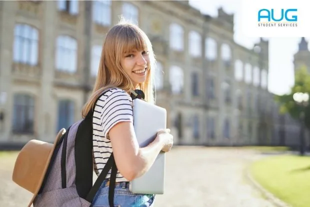 Parents reviewing a study abroad guide with their teenage child at home